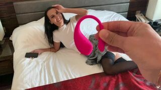 A girl plays with a toy and reaches climax under her partner's control