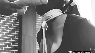BDSM sex with a bound slave who gets a big dildo in their mouth and pussy