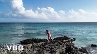 A sexy girl is completely naked on the beach, enjoying the freedom