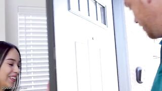 The petite girl is being tutored at home by a handsome guy