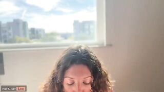 A cute woman has sex in front of passers-by from the hotel window