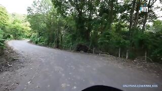 A girl is having her first ride on a motorbike with stranger