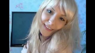 Blonde caresses her pussy with fingers in solo action