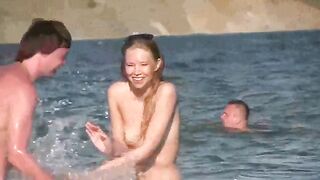 A hot mature woman is completely naked on the beach