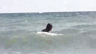Girls sunbathe without swimsuits on the beach, enjoying a sensual experience