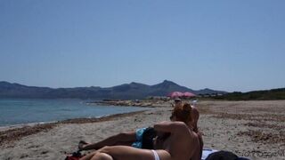 A blowjob in public on the beach with a happy end