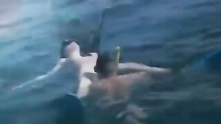 Two aqua sex workers have underwater sex right in the sea
