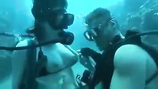 Two aqua sex workers have underwater sex right in the sea