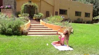 A blonde in 4K is having fun on the lawn with a strong man