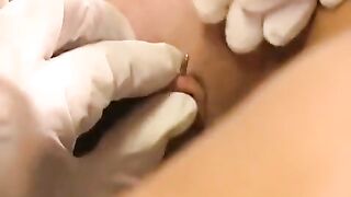 A girl with a clit piercing plays with her new sex toy
