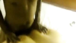 A fat woman lays down on two guys with her big boobs and ass
