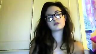 A student with glasses plays with her tits and ass in a video chat