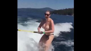 Topless beauty riding on the water skiing is a very exciting view