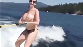 Topless beauty riding on the water skiing is a very exciting view