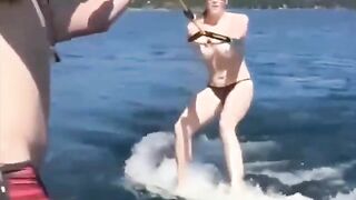Topless beauty riding on the water skiing is a very exciting view