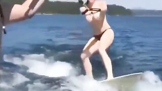 Topless beauty riding on the water skiing is a very exciting view