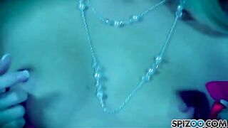 A blonde girl caresses herself with a big dildo
