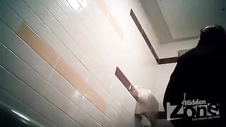 The camera is secretly filming in the woman's toilet