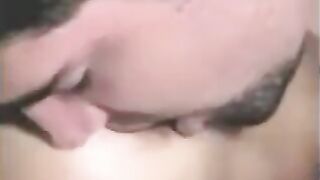 A guy fucked by a strapon, while another girl fingers his cock with her hand