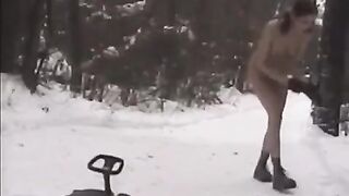 Nude girls have fun with snowballs on the street during the winter