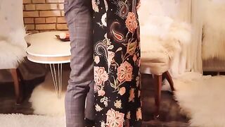 A sexy girl in a long black dress and stockings is fucking with passion