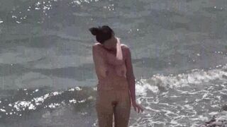 A couple of nudists enjoy a romantic evening on the beach