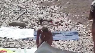 A couple of nudists enjoy a romantic evening on the beach