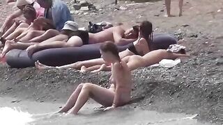 A couple of nudists enjoy a romantic evening on the beach