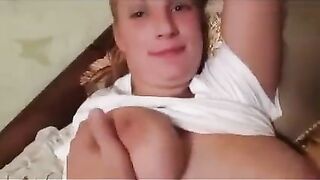 A pregnant girl has a photo session with her big boobs