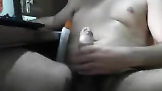 Guy sits in front of the computer and masturbates his dick