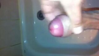 The kid caresses his dick under the water pressure in the shower