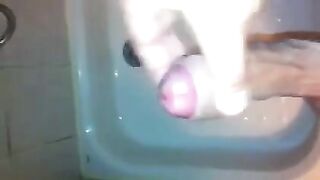 The kid caresses his dick under the water pressure in the shower