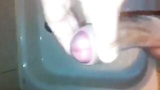 The kid caresses his dick under the water pressure in the shower