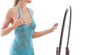 A cute girl is making erotic moves in front of the mirror