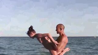 Acrobatic nudists have an intense sex on the nude beach