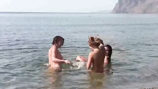 A group of naked people enjoy a day at the beach