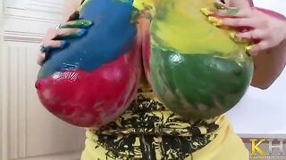 The artist creates a picture while masturbating with her big tits