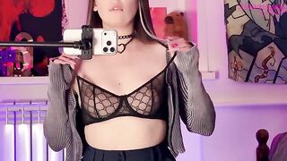 The girl plays with a big dildo in front of the mirror, showcasing her alternative style